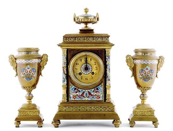 Appraisal: French brass and champleve clock garniture circa urn finial and