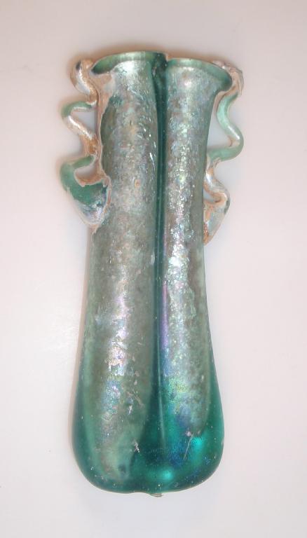 Appraisal: A late Roman greenish-blue double-bodied glass balsamarium the folded hollow-tubular