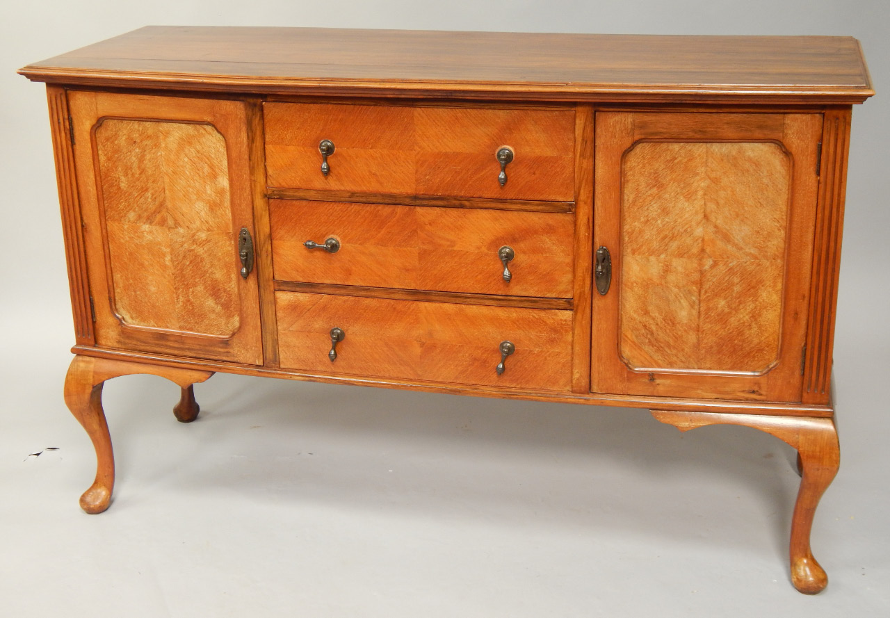 Appraisal: A George V walnut sideboard with slightly bowed front and