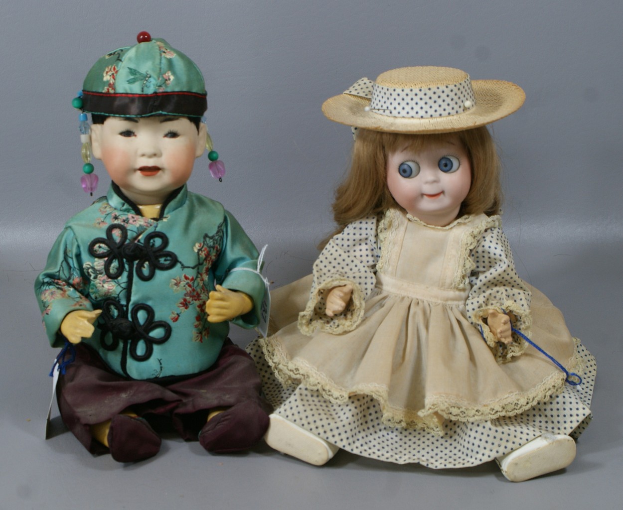 Appraisal: Reproduction Kestner Dolls the larger Kestner Googly the Asian baby