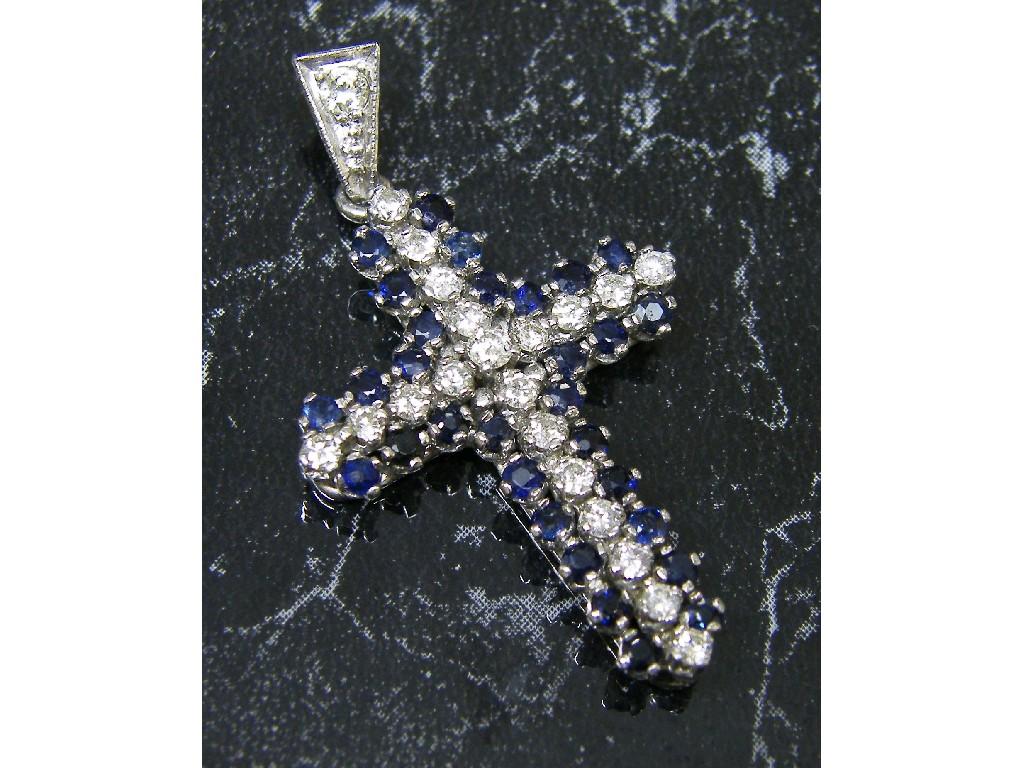 Appraisal: White gold brilliant cut diamond and sapphire cross pendant gm