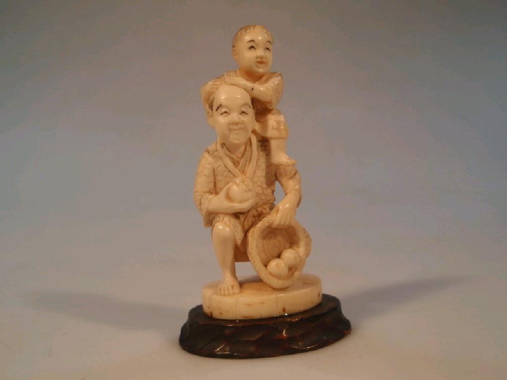 Appraisal: A Japanese ivory figure group carved as a farmer and