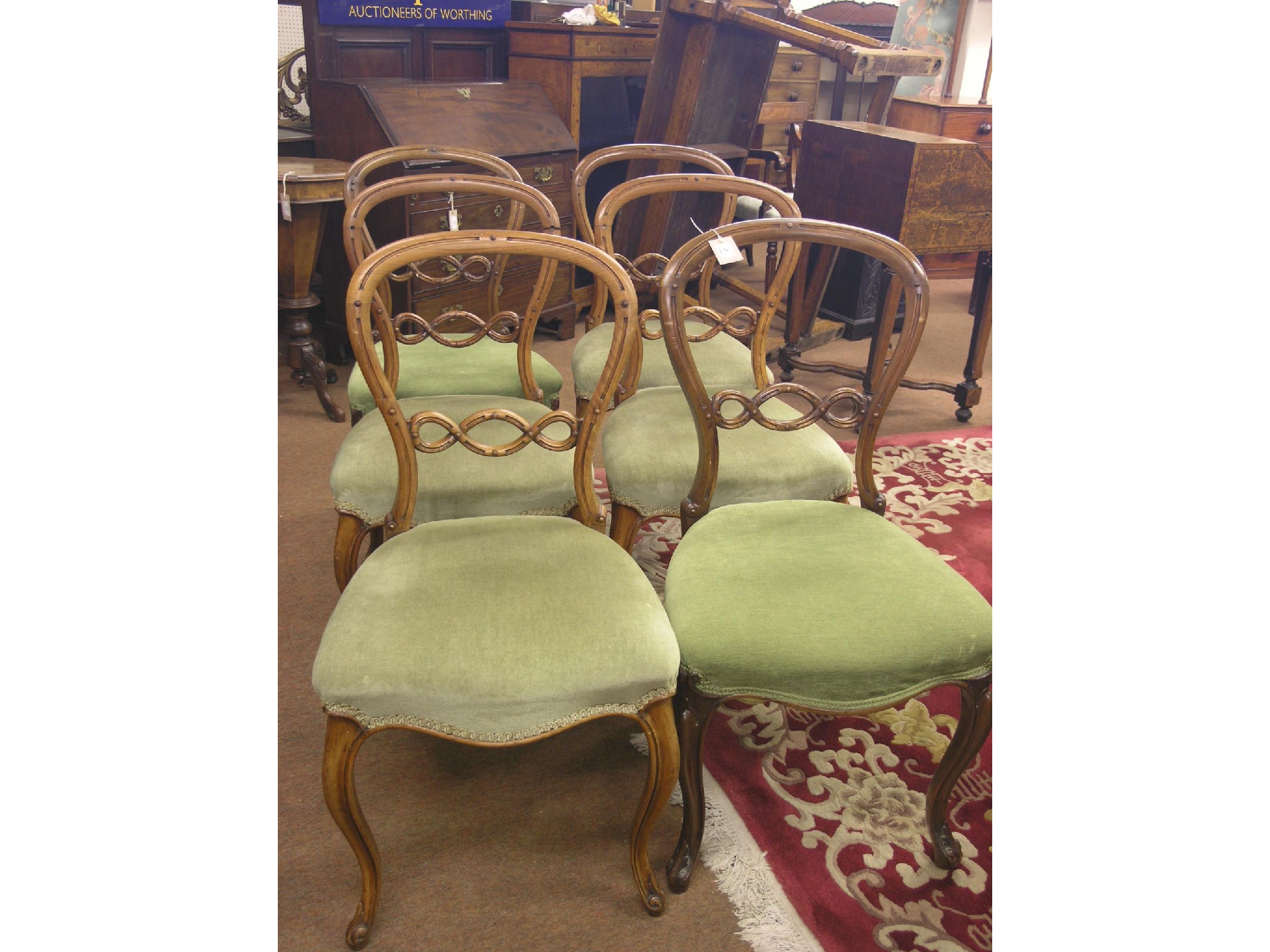 Appraisal: A matched set of six Victorian walnut balloon-back dining chairs