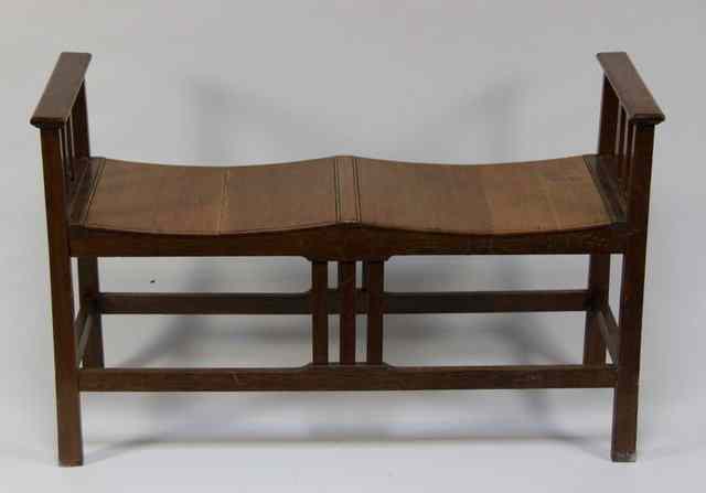 Appraisal: An oak two seat window-seat in the Cotswold Arts Crafts