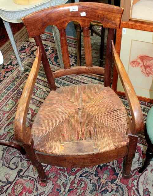 Appraisal: A VICTORIAN FRUITWOOD ARMCHAIR with arched splat back rush seat