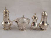 Appraisal: A silver three piece cruet set and an additional pepper