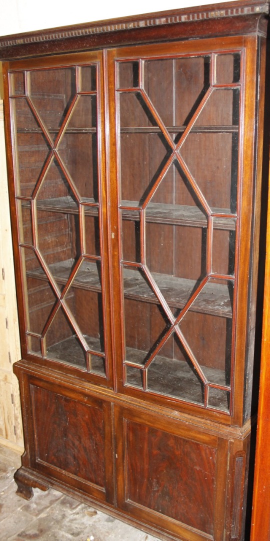 Appraisal: An George III style mahogany bookcase the overhanging moulded cornice