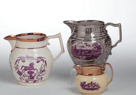 Appraisal: THREE STAFFORDSHIRE PURPLE TRANSFER-PRINTED SILVER RESIST AND PINK LUSTRE JUGS