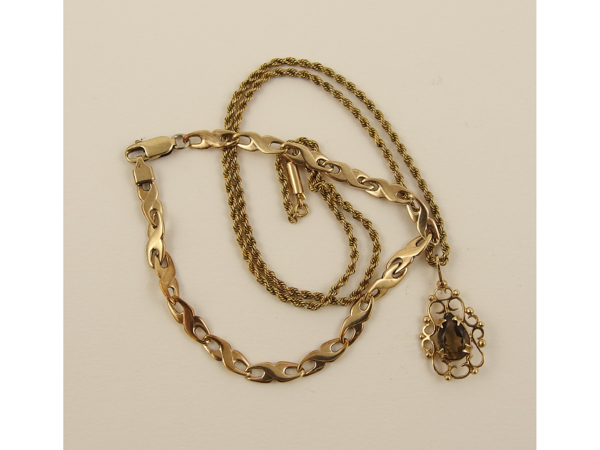 Appraisal: A ct smoky quartz pendant and chain and a ct