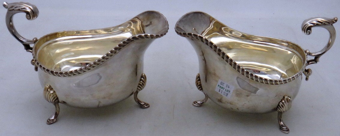 Appraisal: A pair of silver sauce boats with scrolling handles each