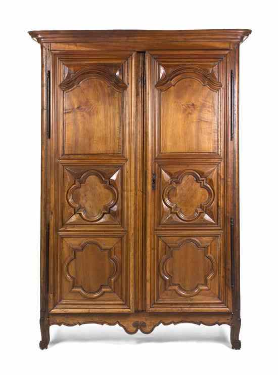 Appraisal: A Louis XV Provincial Walnut Armoire having a flaring molded