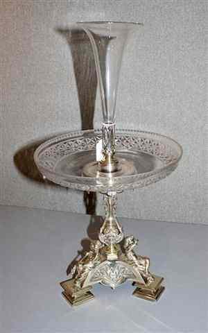 Appraisal: A SILVER PLATED CENTRE STAND on tripod base with seated