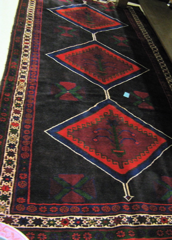 Appraisal: PERSIAN TRIBAL CARPET centering a column of three diamond-shaped pole