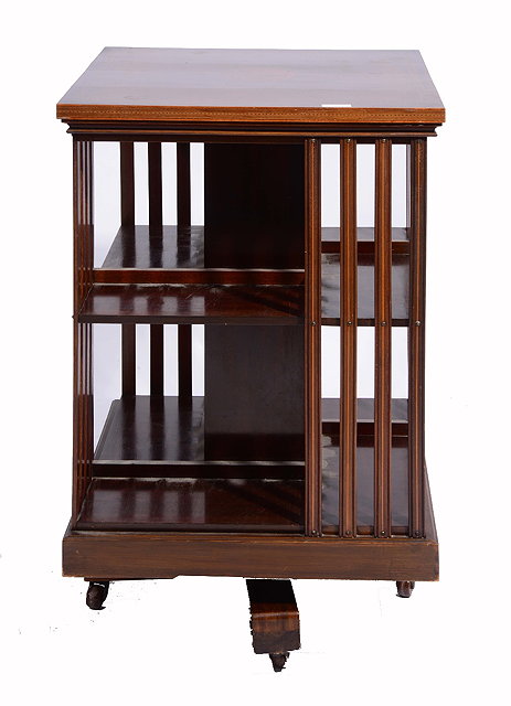 Appraisal: AN EDWARDIAN MAHOGANY REVOLVING BOOKCASE with slat sides and boxwood