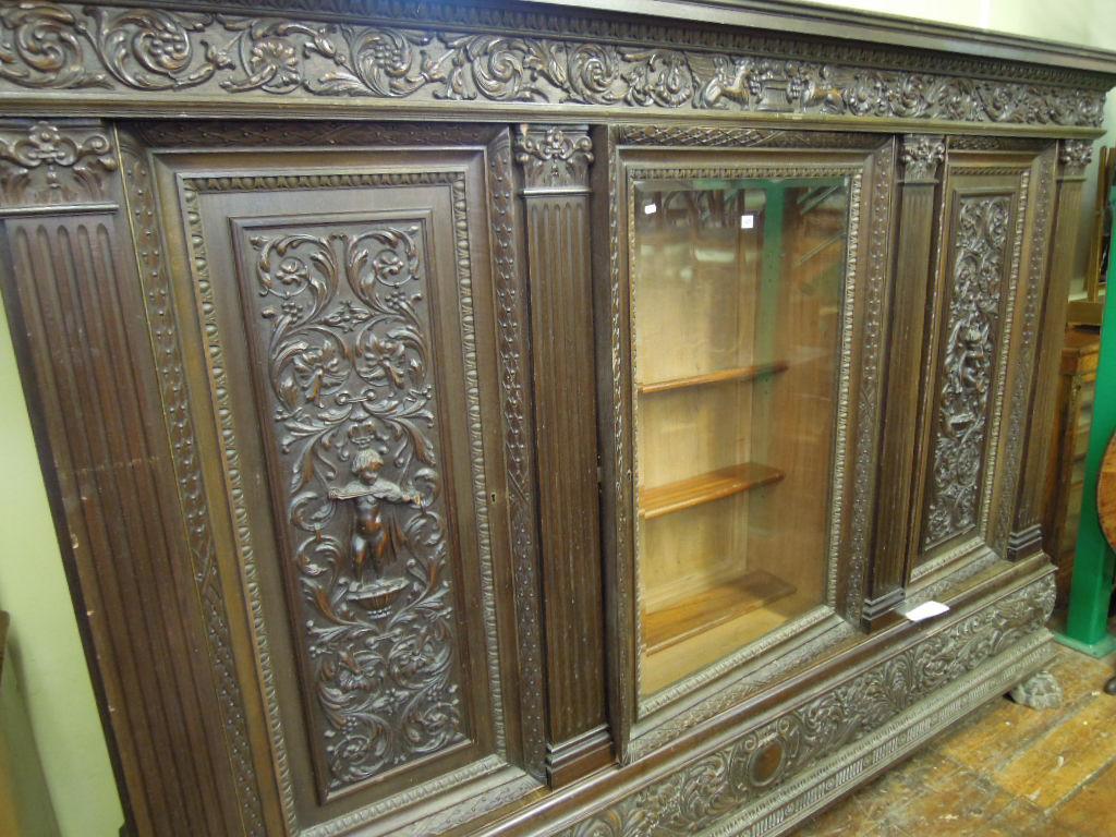 Appraisal: A substantial oak side cabinet with stepped and moulded pediment