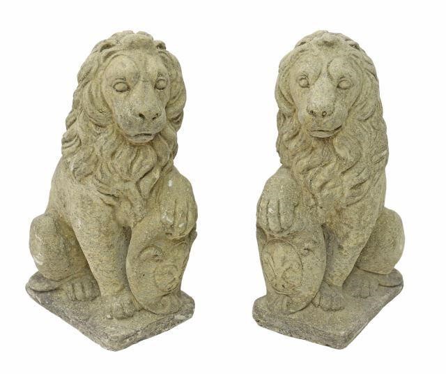 Appraisal: pair Cast stone garden statuary seated lion one paw resting