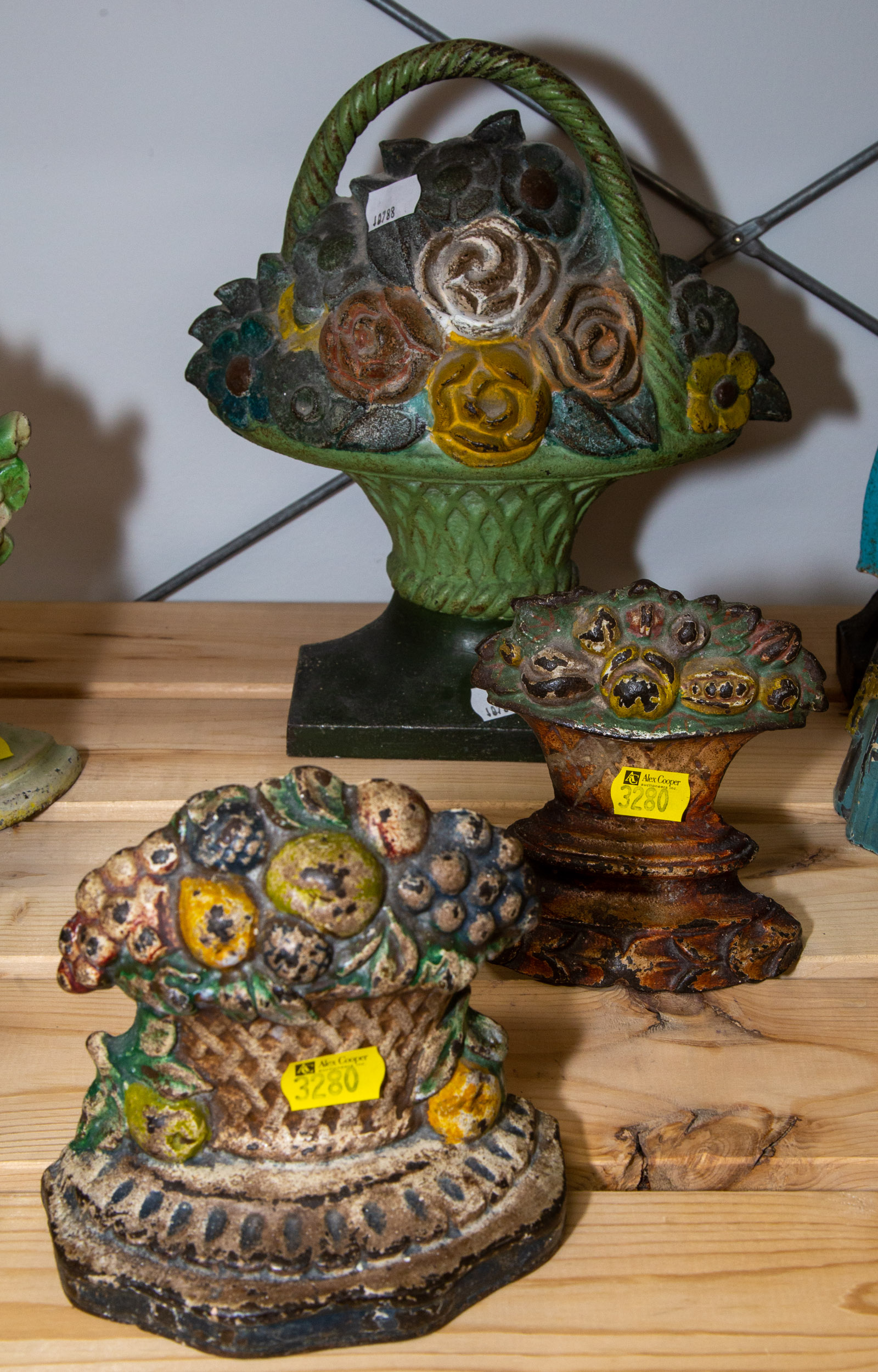 Appraisal: THREE CAST IRON DOOR STOPS Modeled as flower baskets late