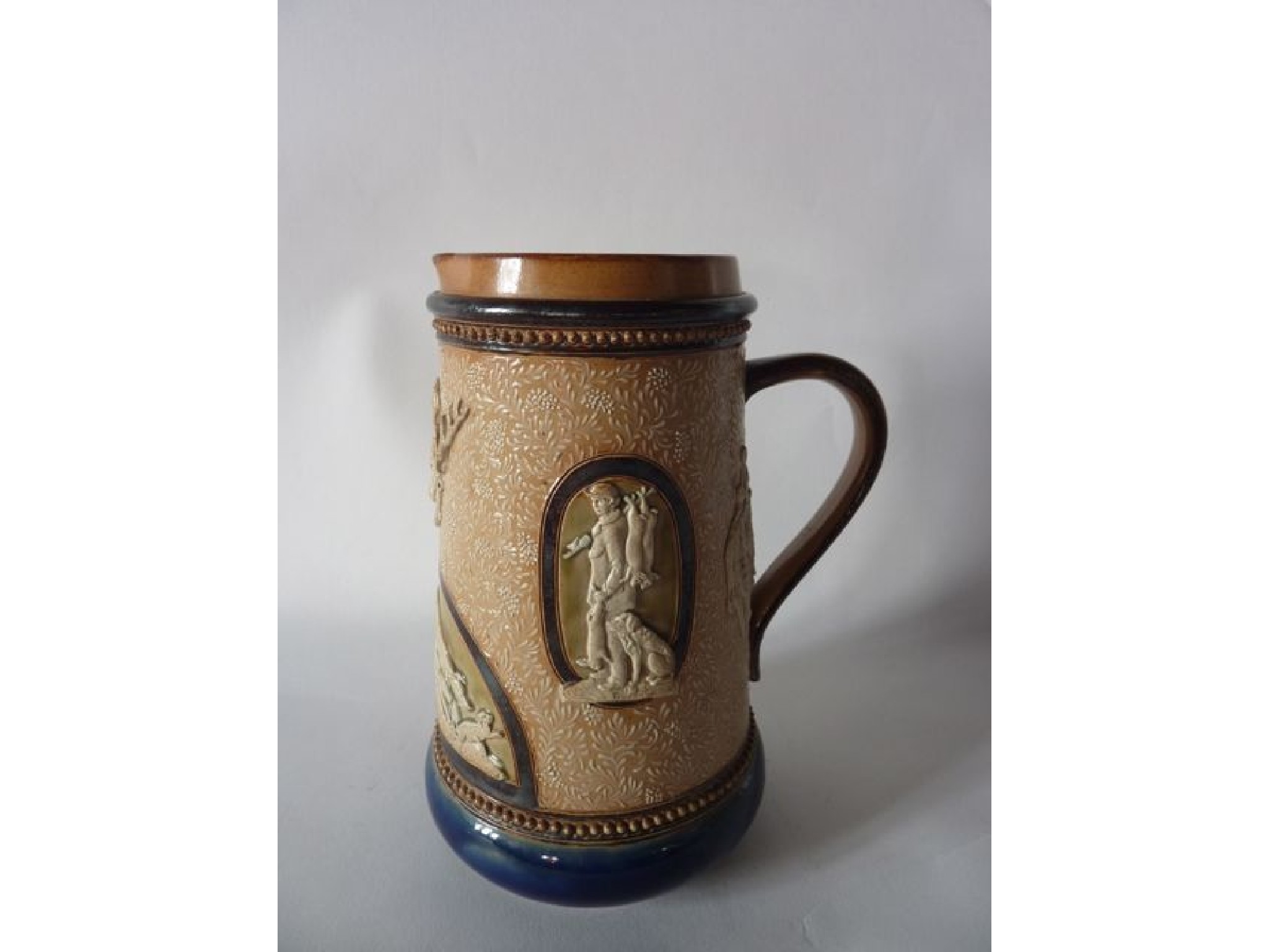 Appraisal: A Doulton Lambeth stoneware tankard with relief moulded panels of