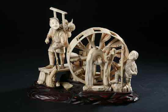 Appraisal: JAPANESE IVORY OKIMONO OF TWO MEN AND A WHEEL Meiji