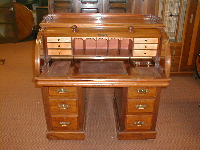 Appraisal: A late Victorian American walnut cylinder top writing desk with