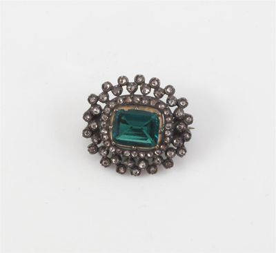 Appraisal: A Victorian emerald and diamond brooch The cushion shaped emerald