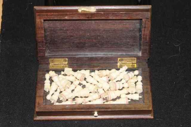 Appraisal: A MINIATURE IVORY CHESS SET in rosewood box and ivory