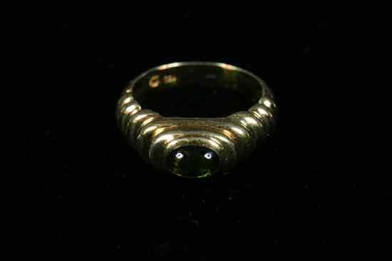 Appraisal: K YELLOW GOLD AND PERIDOT RING Oval peridot cabochon centered