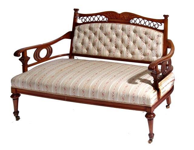 Appraisal: A LATE VICTORIAN WALNUT FRAMED SETTEE with acanthus carved scroll