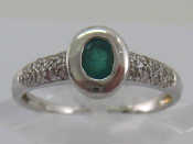 Appraisal: A white metal tests carat gold emerald and diamond ring