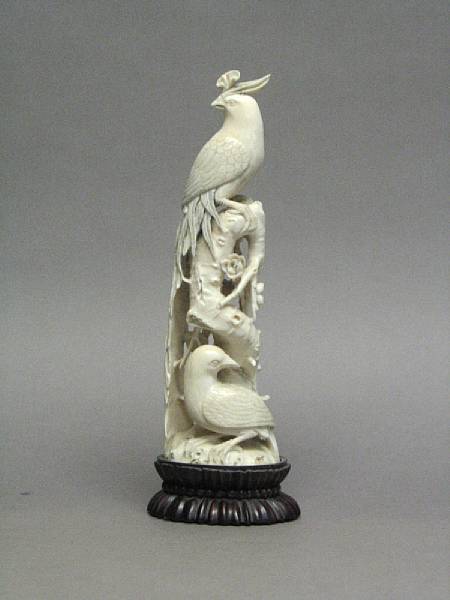 Appraisal: A Chinese carved ivory phoenix Perched on a deeply undercut