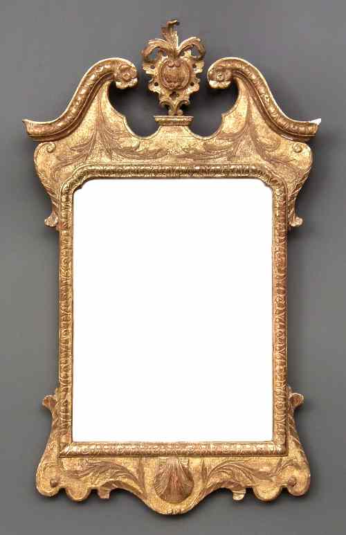 Appraisal: A George II gilt rectangular wall mirror with moulded scroll