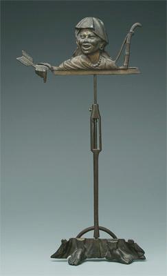 Appraisal: Patinated cast iron frame stand formed as turbaned man holding