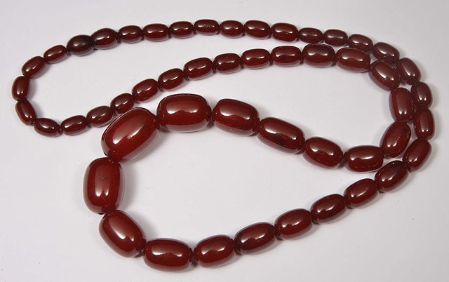 Appraisal: A GRADUATED RED AMBER BEAD NECKLACE approximate cm grams