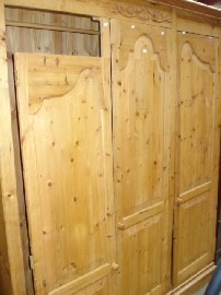 Appraisal: An aged pine three door wardrobe with waxed finish m