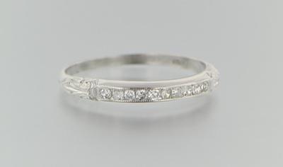 Appraisal: A Platinum and Diamond Band Platinum band set across the