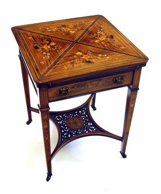 Appraisal: A LATE VICTORIAN ROSEWOOD ENVELOPE TABLE with stringing and floral