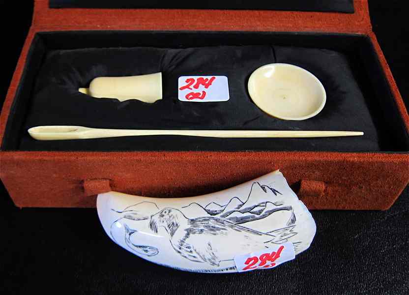 Appraisal: TWO IVORY CARVINGS an American carved whale's tooth with scrimshaw