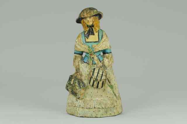 Appraisal: LADY WITH HAIRBOX AND CARPET BAG DOORTSTOP Signed Sarah Symonds