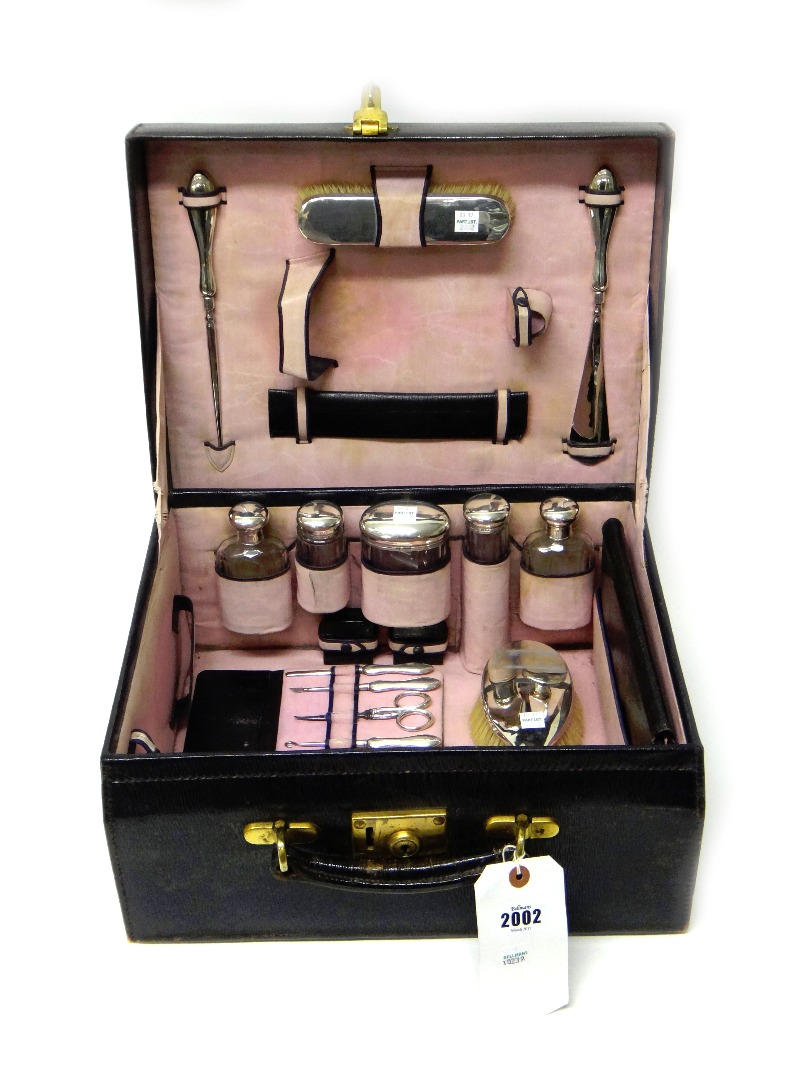 Appraisal: A lady's silver mounted travelling toilet set including a hand