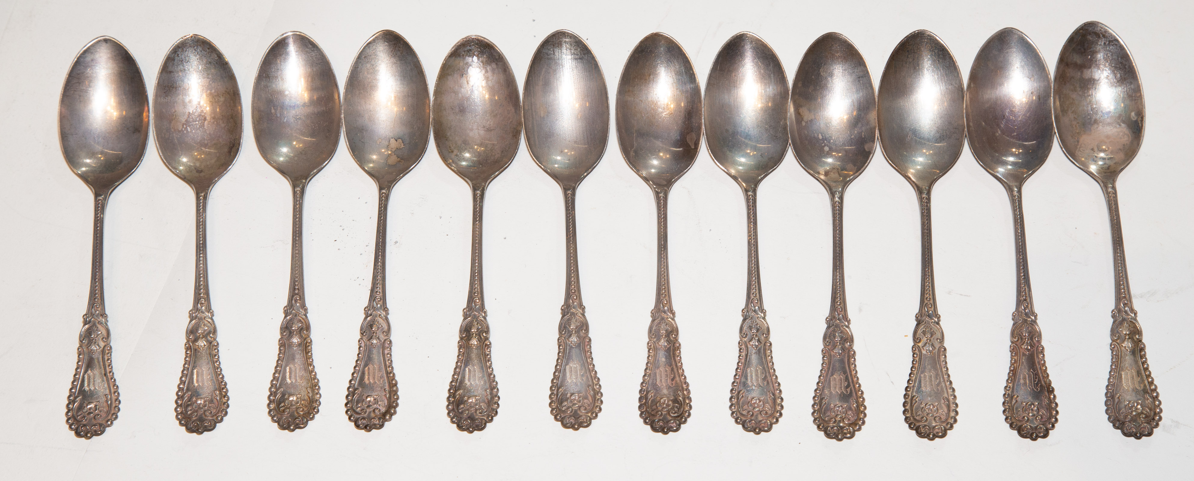 Appraisal: TWELVE STERLING MONOGRAMMED TEASPOONS in L ozt