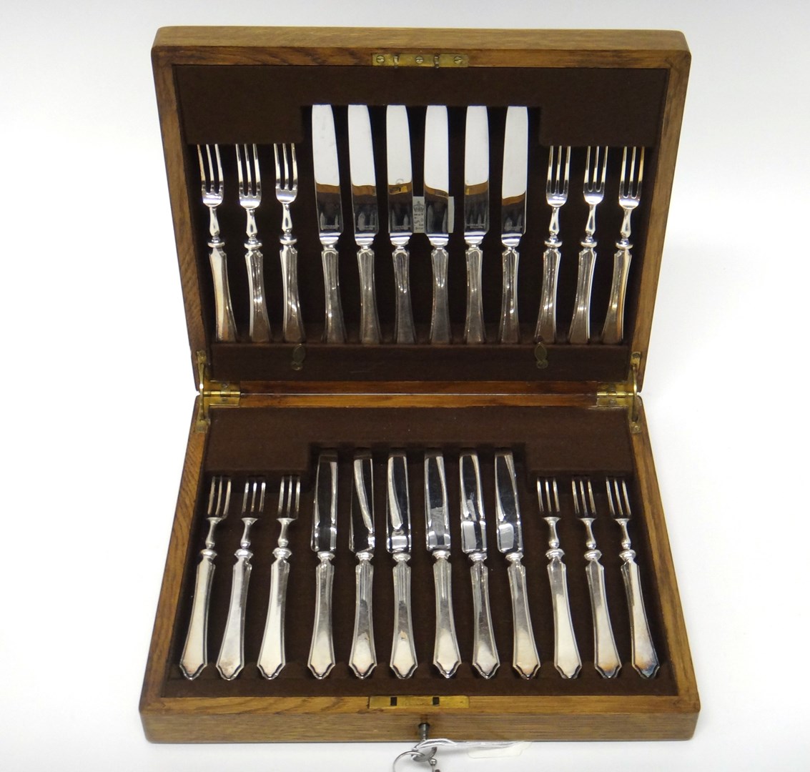 Appraisal: A set of twelve pairs of dessert or fruit knives