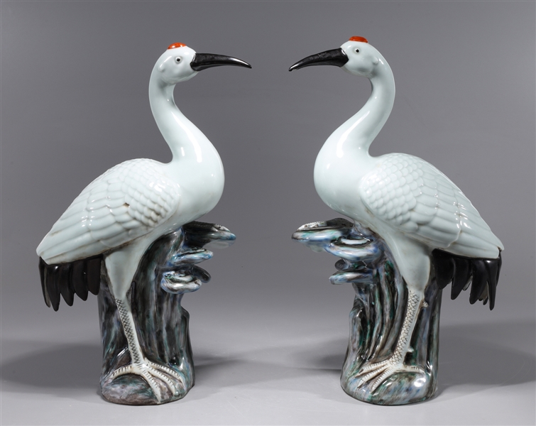 Appraisal: Pair of Chinese porcelain crane statues atop rocks overall good