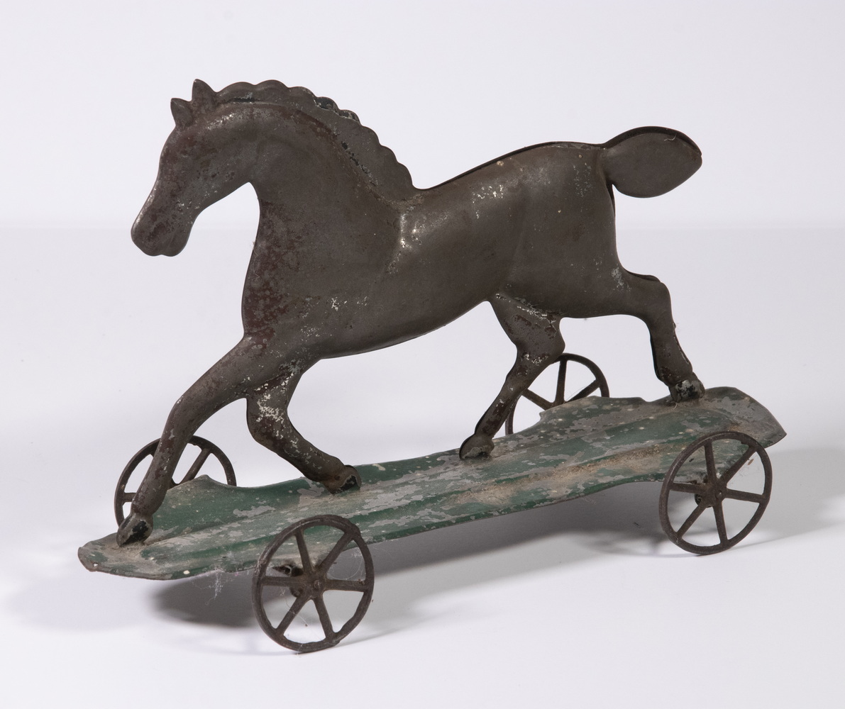 Appraisal: TIN TROTTING HORSE PULL TOY Late th c Pressed Tin