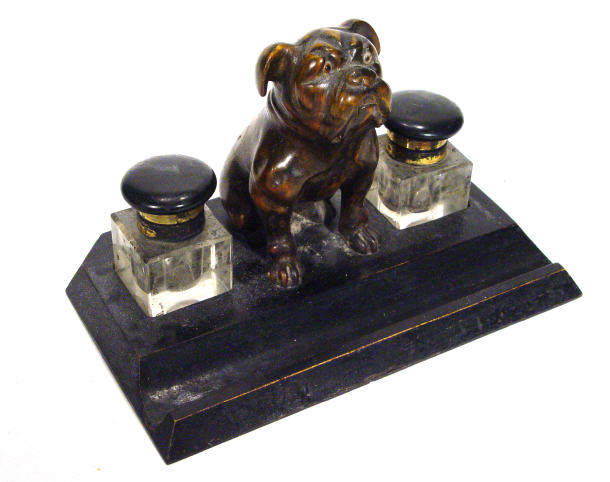 Appraisal: Carved and ebonized wooden desk stand with a central bulldog