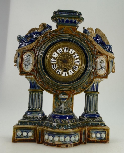 Appraisal: Doulton lambeth stoneware ornate clock the round dial surmounted by