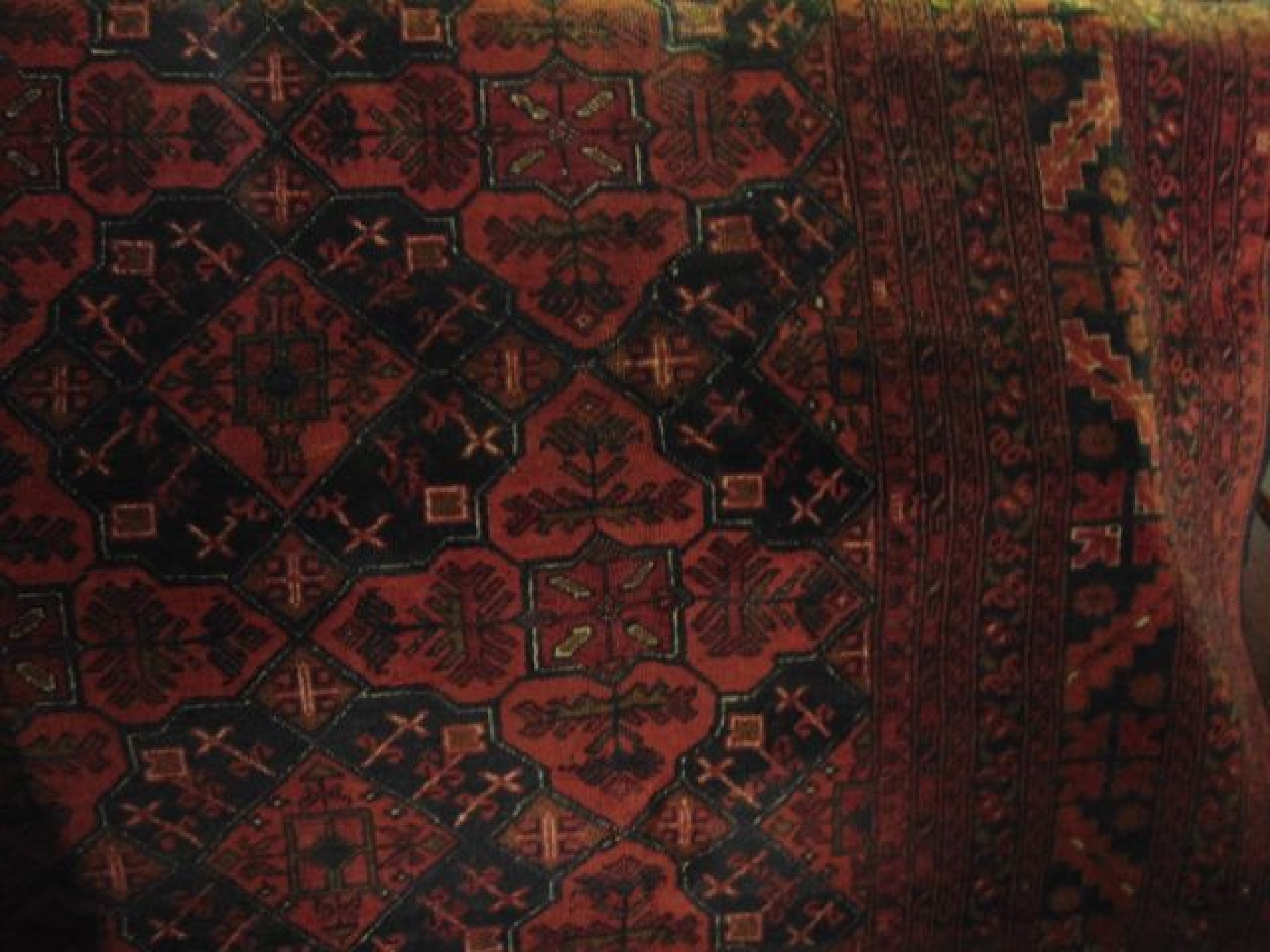 Appraisal: A Persian style red ground carpet with abstract medallion centre