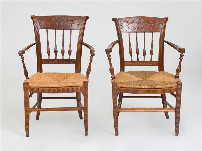 Appraisal: TWO FRENCH PROVINCIAL CARVED BEECHWOOD ARMCHAIRS Each with rush seats