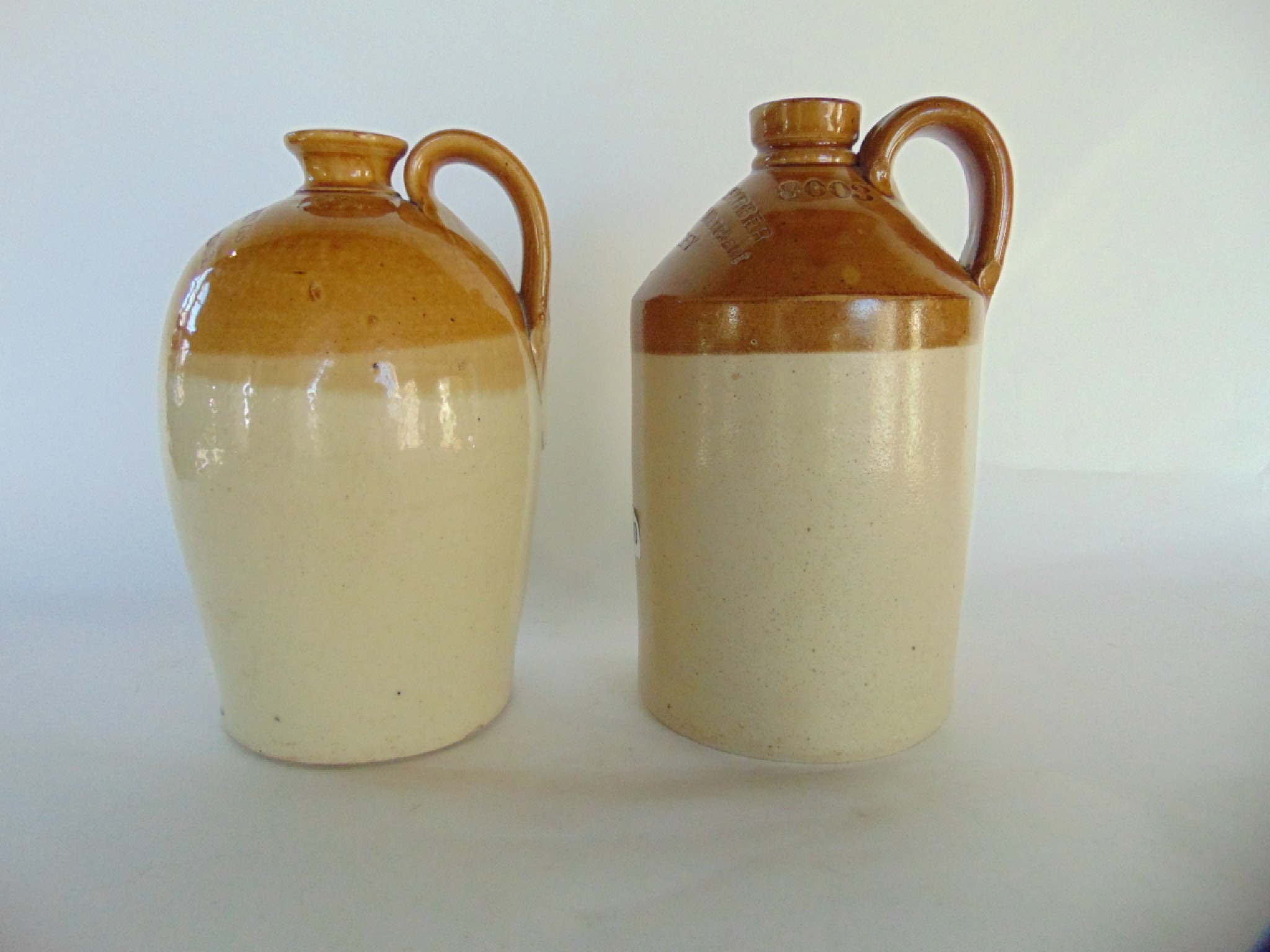 Appraisal: Two small salt glazed stoneware flagons with merchants marks of