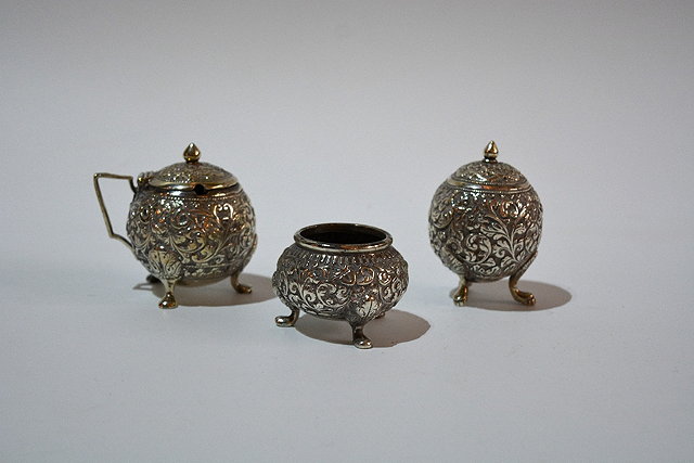 Appraisal: An Indian white metal three piece condiment setof spherical form