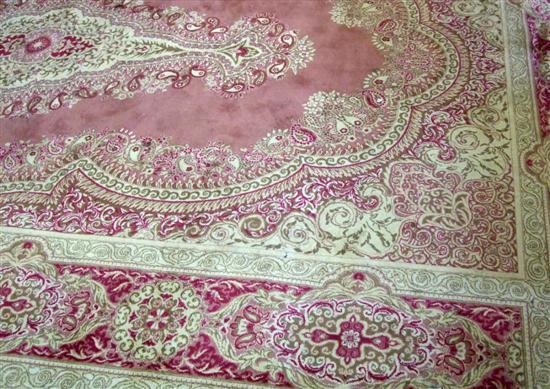 Appraisal: Twentieth century machine made pink ground carpet with shaped cartouche